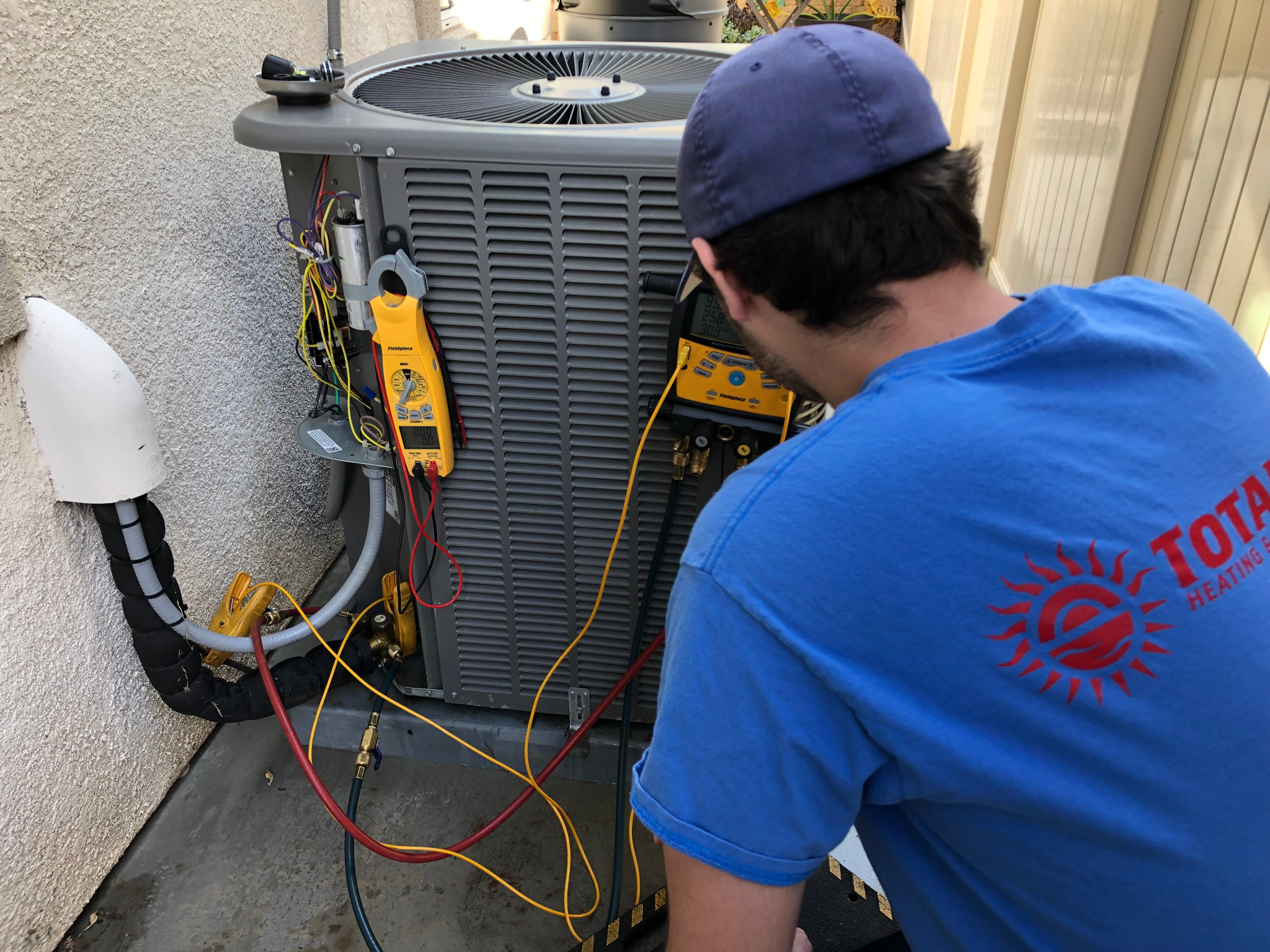 A Total Air technician performs an AC repair.